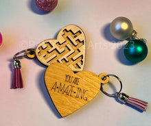 Load image into Gallery viewer, Valentine&#39;s Day gift, heart-shaped wooden maze puzzle with metal bead and clear acrylic top, with attached metal ring and colorful tassel by @belcreativearts
