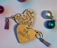 Load image into Gallery viewer, Valentine&#39;s Day gift, heart-shaped wooden maze puzzle with metal bead and clear acrylic top, with attached metal ring and colorful tassel by @belcreativearts
